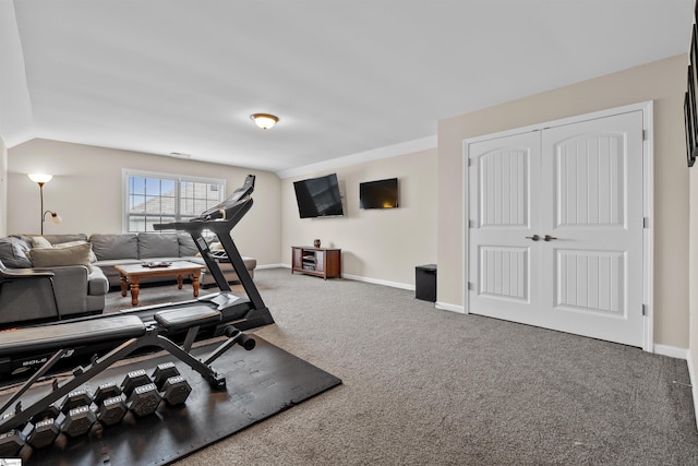 exercise area with vaulted ceiling, carpet, baseboards, and visible vents