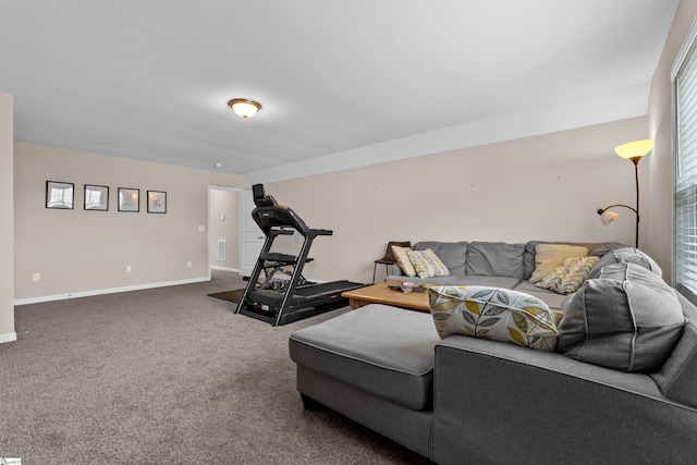 carpeted living area with baseboards