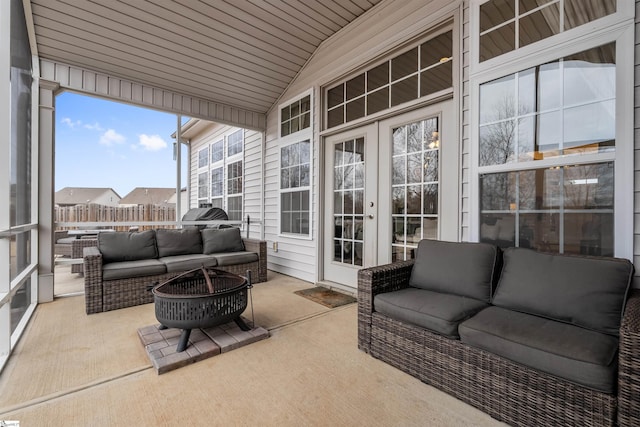 sunroom / solarium featuring french doors, lofted ceiling, and wooden ceiling