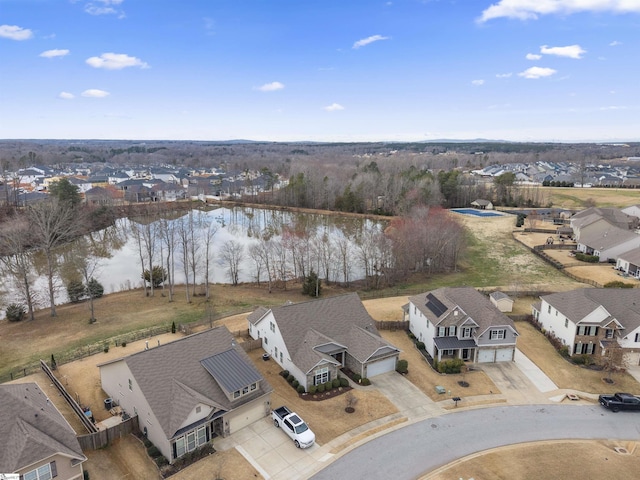 drone / aerial view featuring a residential view and a water view