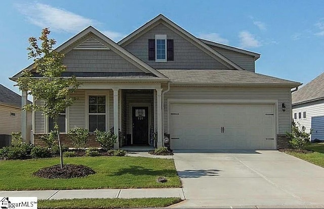 craftsman house with an attached garage, covered porch, concrete driveway, and a front yard