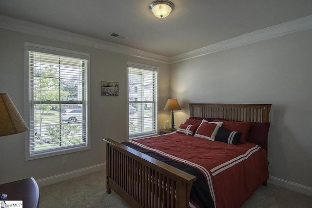 bedroom with visible vents, carpet floors, baseboards, and ornamental molding