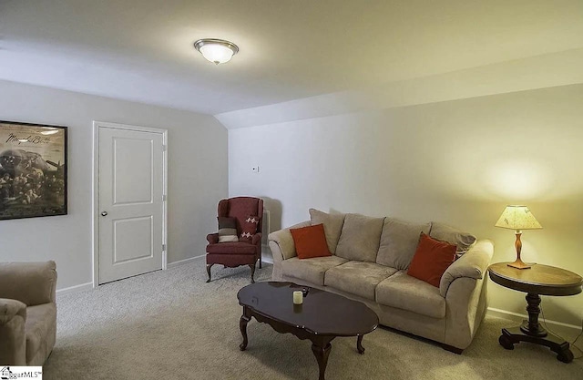 carpeted living room with lofted ceiling and baseboards