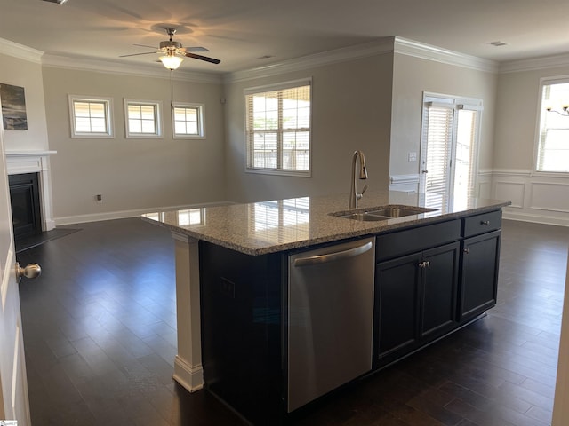 kitchen featuring dishwasher, ornamental molding, a fireplace with flush hearth, and a sink