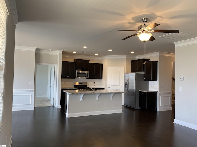 kitchen featuring a kitchen breakfast bar, dark wood finished floors, stainless steel appliances, light stone countertops, and ceiling fan