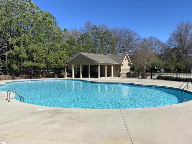 pool featuring a patio and fence