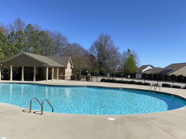 community pool featuring a patio area and fence