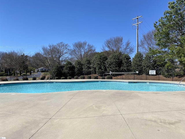 community pool featuring a patio area and fence