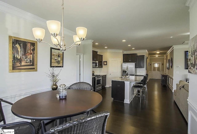 dining space featuring recessed lighting, a notable chandelier, dark wood-type flooring, and ornamental molding