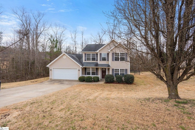 traditional-style home with driveway, a front lawn, and an attached garage