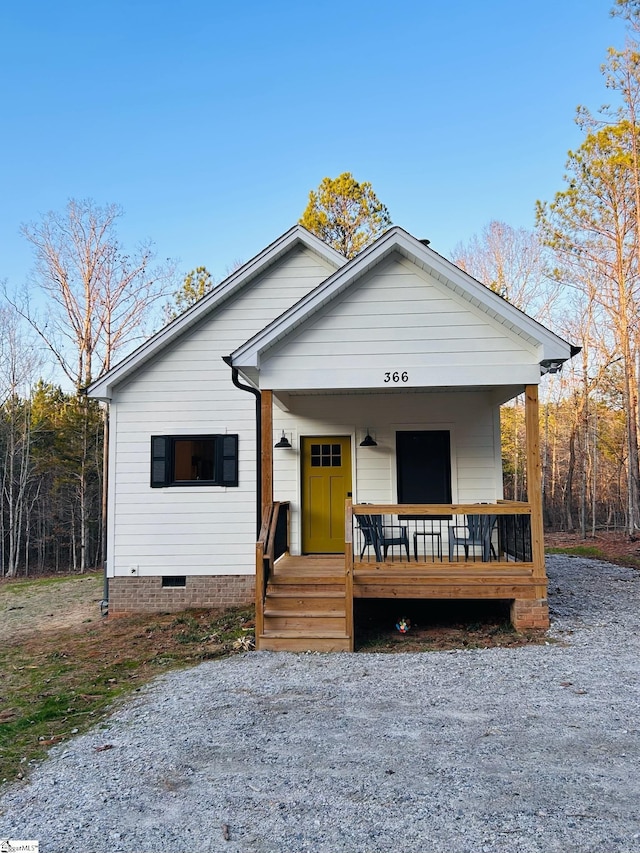 view of front of house with crawl space and covered porch