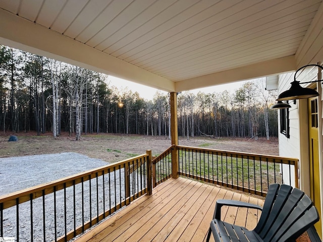 wooden deck featuring a forest view