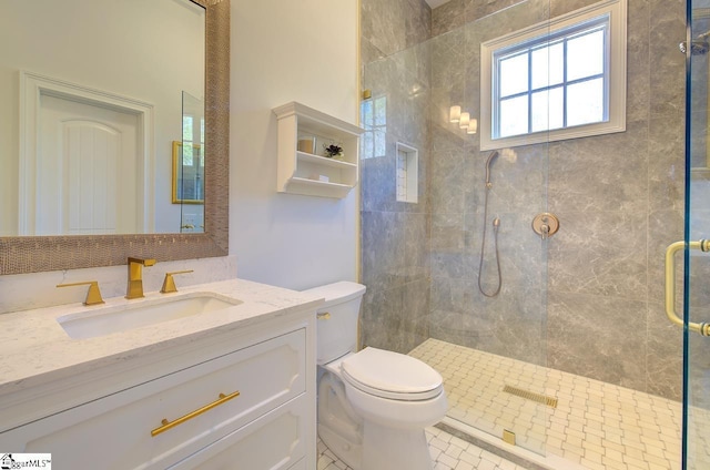 bathroom featuring toilet, a stall shower, and vanity