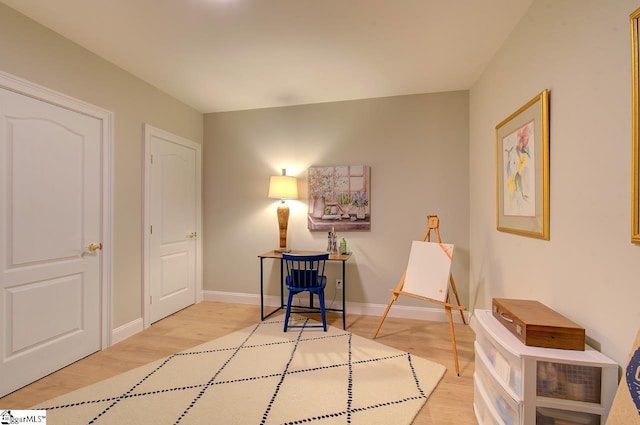 living area with wood finished floors and baseboards