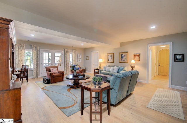 living area featuring recessed lighting, french doors, baseboards, and light wood finished floors