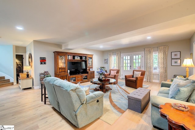 living room with stairs, baseboards, light wood-style flooring, and recessed lighting