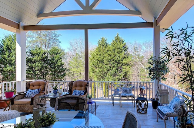 wooden terrace with an outdoor living space