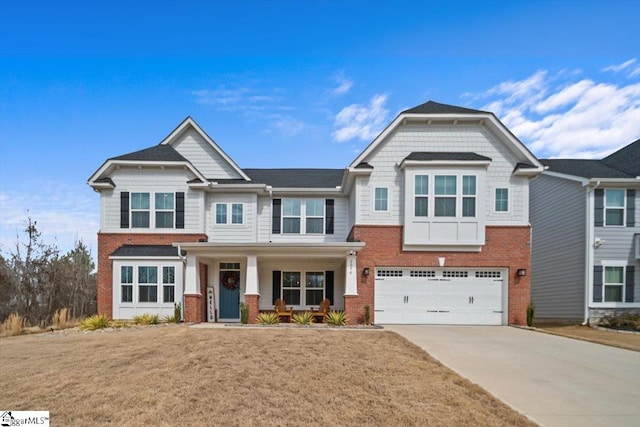 view of front of house with an attached garage, covered porch, concrete driveway, and brick siding