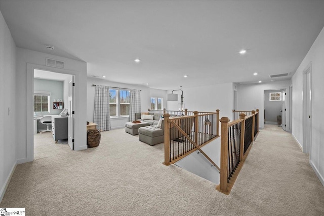 corridor featuring visible vents, carpet flooring, an upstairs landing, and recessed lighting