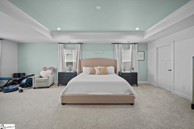 carpeted bedroom featuring baseboards, a tray ceiling, crown molding, and recessed lighting