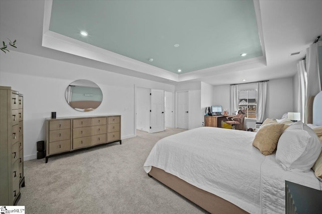 bedroom with a tray ceiling, carpet flooring, baseboards, and recessed lighting