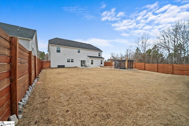 back of house with a lawn, a patio area, and a fenced backyard