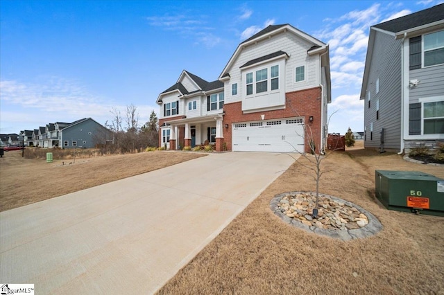 view of front of house featuring an attached garage, concrete driveway, and brick siding