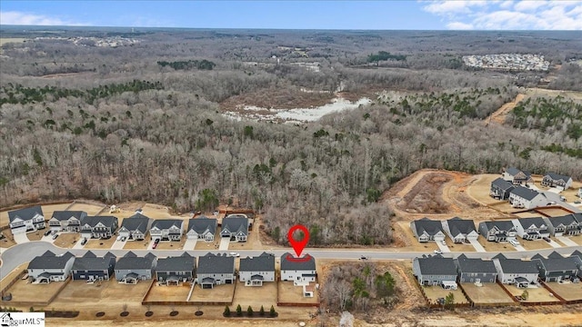 birds eye view of property with a wooded view and a residential view