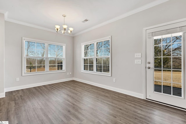 unfurnished dining area with baseboards, crown molding, visible vents, and a notable chandelier