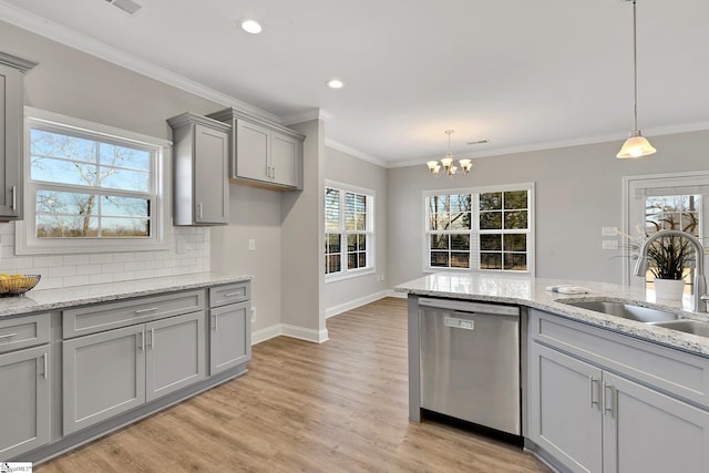 kitchen featuring crown molding, tasteful backsplash, gray cabinets, stainless steel dishwasher, and a sink