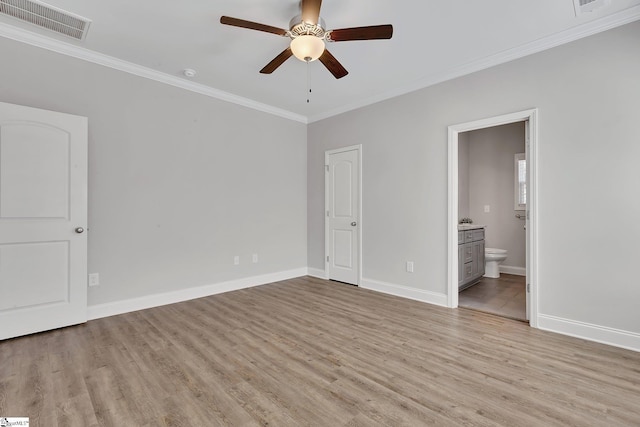 unfurnished bedroom featuring light wood-style floors, baseboards, visible vents, and crown molding