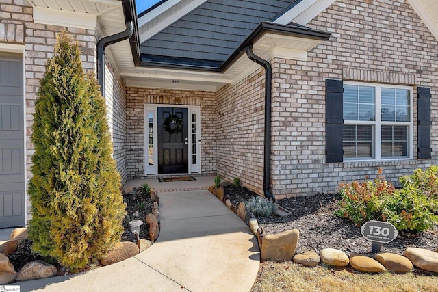 property entrance featuring brick siding