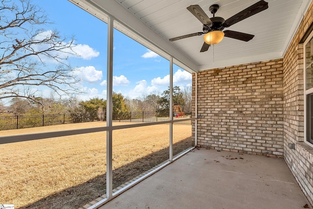 unfurnished sunroom with a ceiling fan