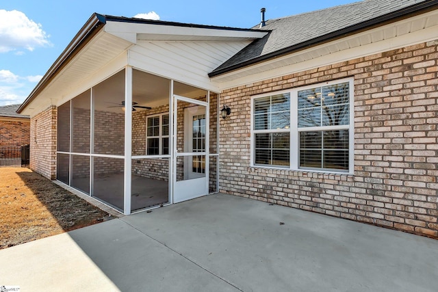 view of patio / terrace featuring a sunroom and ceiling fan