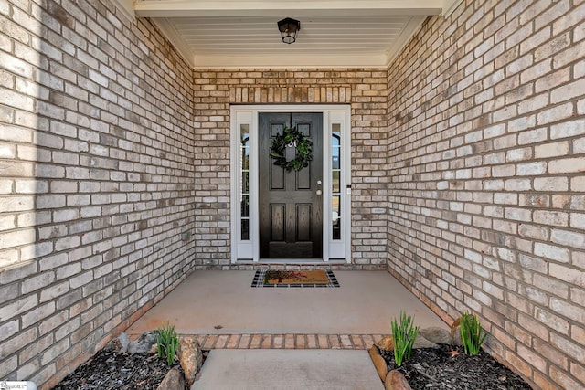 property entrance with brick siding