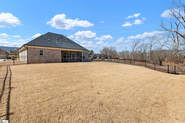 view of yard featuring a sunroom and fence