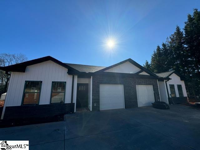 ranch-style house with an attached garage and driveway