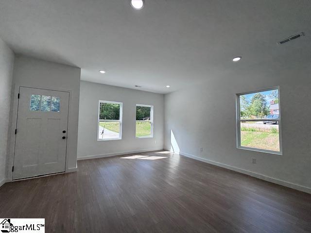 entryway with baseboards, recessed lighting, wood finished floors, and visible vents