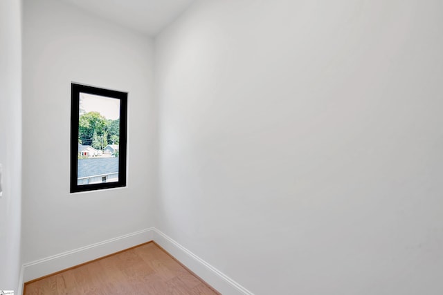 unfurnished room with light wood finished floors and baseboards