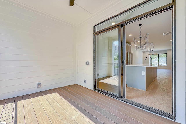 wooden deck featuring visible vents and a sink