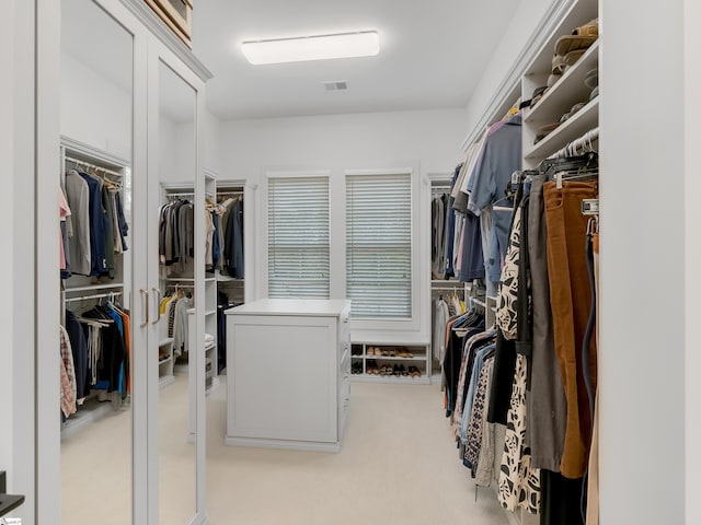 spacious closet with visible vents and light colored carpet