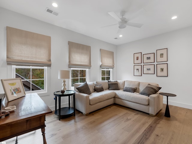 living room with a healthy amount of sunlight, light wood finished floors, visible vents, and recessed lighting