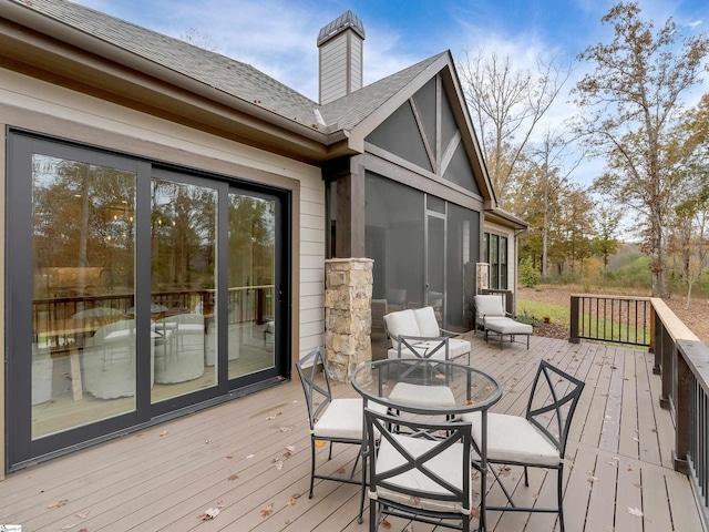 wooden terrace with outdoor dining area