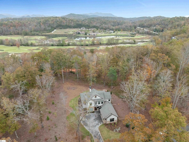 birds eye view of property with a wooded view and a mountain view