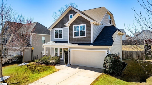 view of front of property featuring a garage, a front yard, concrete driveway, and fence