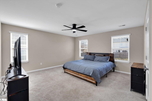 bedroom featuring light carpet, ceiling fan, visible vents, and baseboards