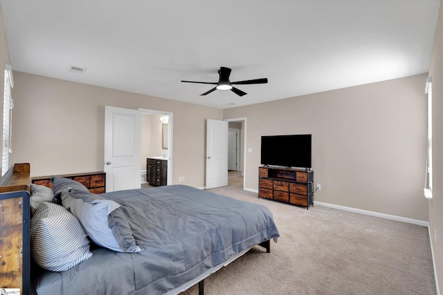 bedroom featuring light carpet, visible vents, baseboards, connected bathroom, and a ceiling fan