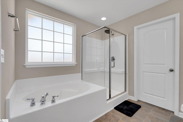 bathroom with a stall shower, recessed lighting, a bath, and tile patterned floors