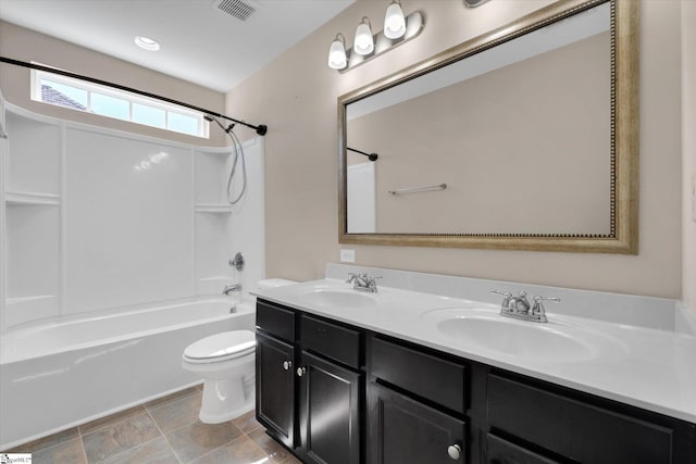 bathroom featuring toilet, bathing tub / shower combination, a sink, and visible vents