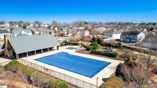 view of pool with a residential view and fence